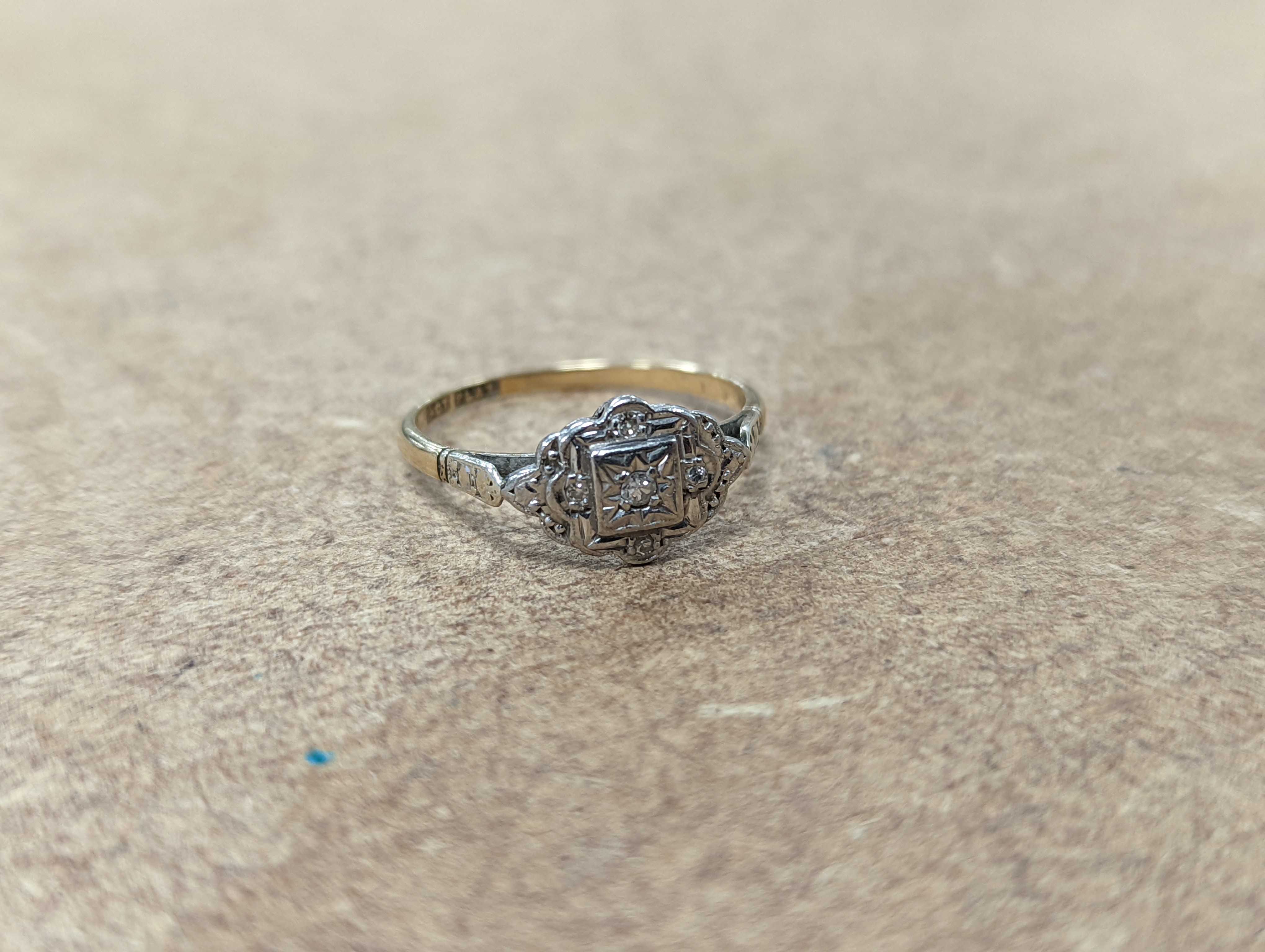 Two 18ct and diamond cluster rings, gross 5.3 grams, a 585 and diamond chip ring, gross 1.7 grams, a 9ct gold gem set ring and two 9ct pendants, gross 8.9 grams.